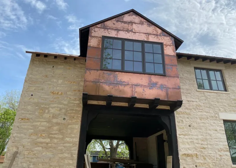 Copper metal panel facade on a stone building for Skylight Installation in Trotwood